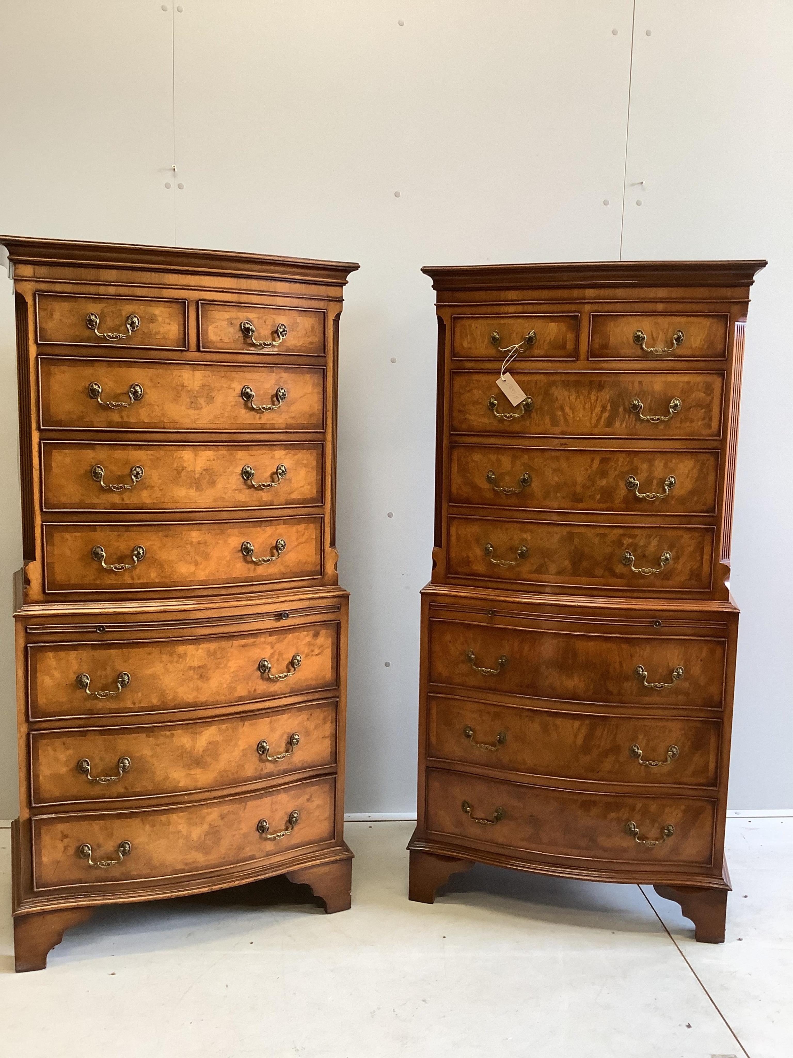 A pair of small reproduction George III style walnut bow front walnut chest on chests, width 72cm, depth 44cm, height 152cm. Condition - good